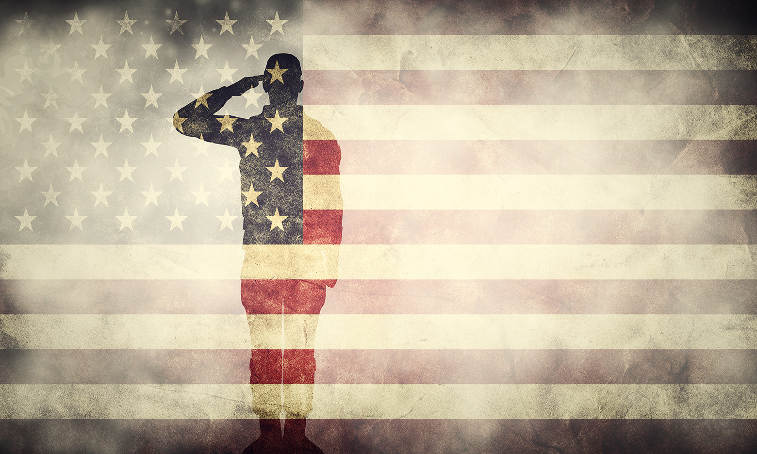 A veteran silhouetted on top of an American flag - veteran franchise business ownership