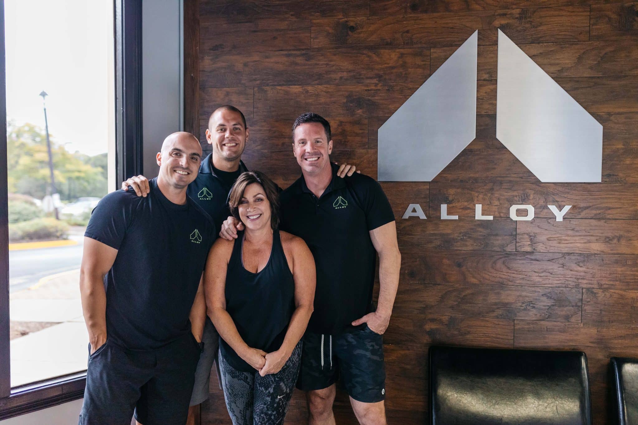 Rick Mayo poses with the leadership team at the Alloy franchise business