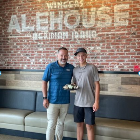 Wingers alehouse franchise owner Brad McDougal with his oldest son, Talin