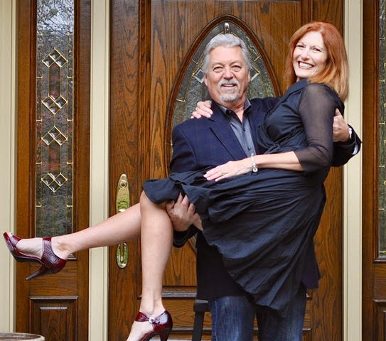 Franchise news - A man holding a woman in the doorway of a house