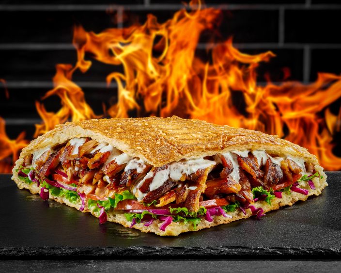 Doner Haus sandwich in front of flames